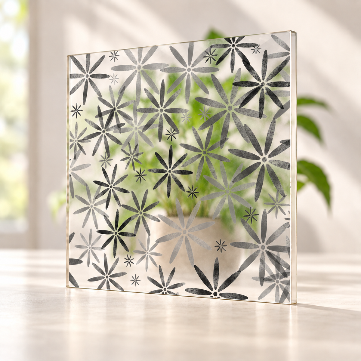 Flower Power printed pattern on a translucent frosted panel, with softly diffused foliage visible through the unprinted spaces.